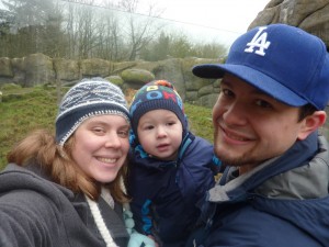 A family shot in front of the lions.