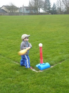 Elias hitting the ball in the rain. He chose to wear his sunglasses even though it was raining. 