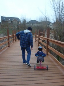 Elias propelling himself on his tricycle!