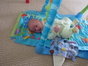 Having fun in the kick and crawl while Mommy makes breakfast.