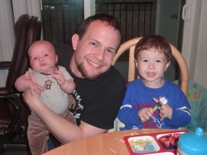 Daddy poses with his boys at the end of dinner.