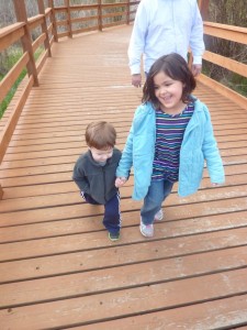 Elias and Audrey hold hands on a short walk.