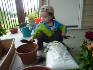 Elias filling the pots with potting soil...or "we're doing dirt!" as he put it.