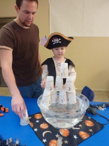 Elias and Daddy playing the cup stacking game.