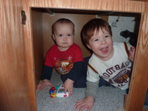 The boys playing in the bathroom cupboard.